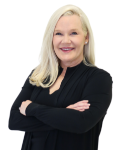 Smiling blonde woman wearing black with arms crossed. Headshot of Dr. Sarah Sawyer, dermatologist in Birmingham, Alabama.